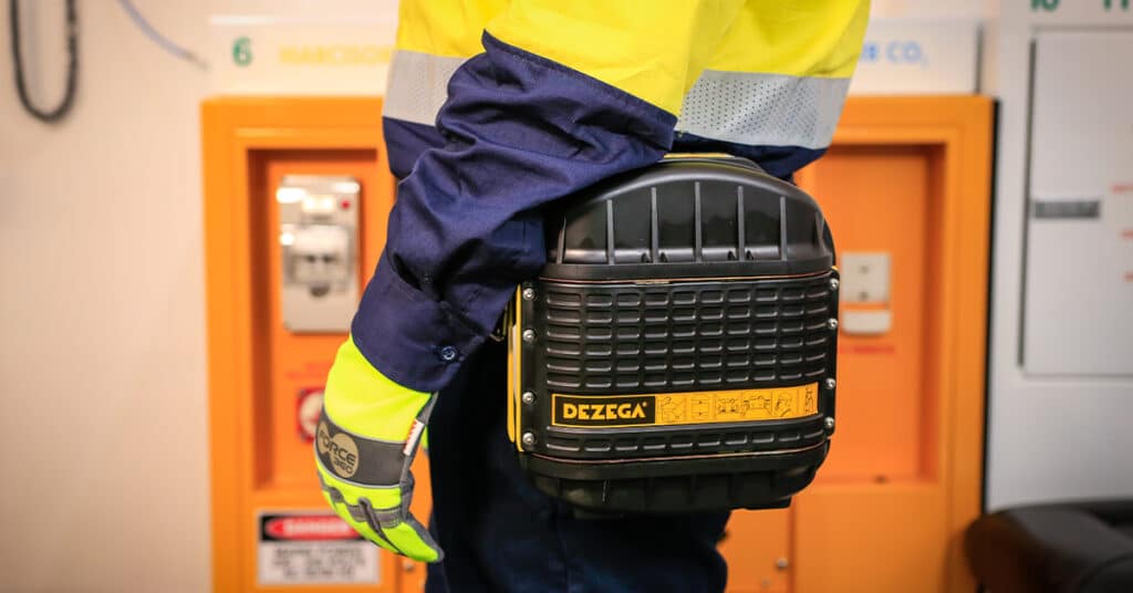 Underground mine worker carrying a DEZEGA CARBO 60 60-minute self-rescuer on their waist